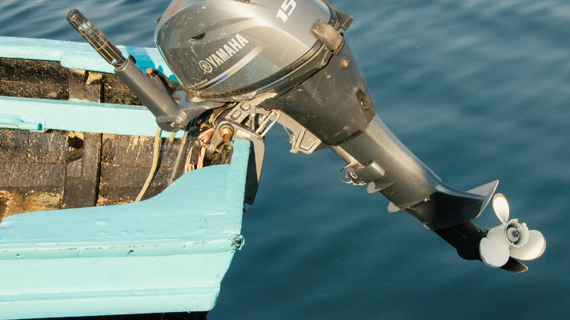 Yamaha F15 outboard motor mounted on a small tender transom